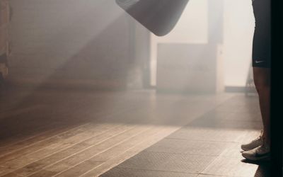 Athlete stretching on a clean floor space.
